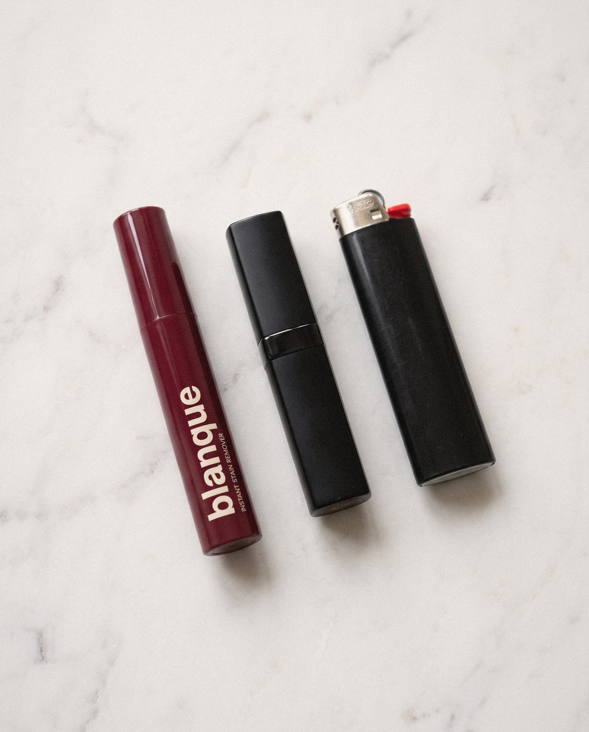 The blanque pen beside a lipstick and a lighter, for scale