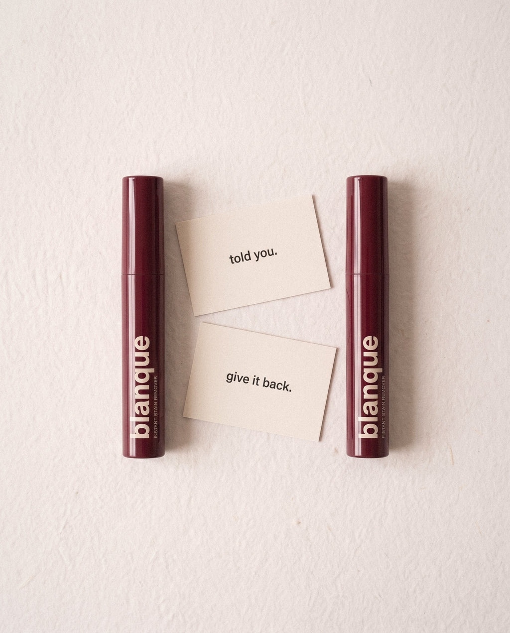 Two pens and the two cards: Told you. and Give it back.