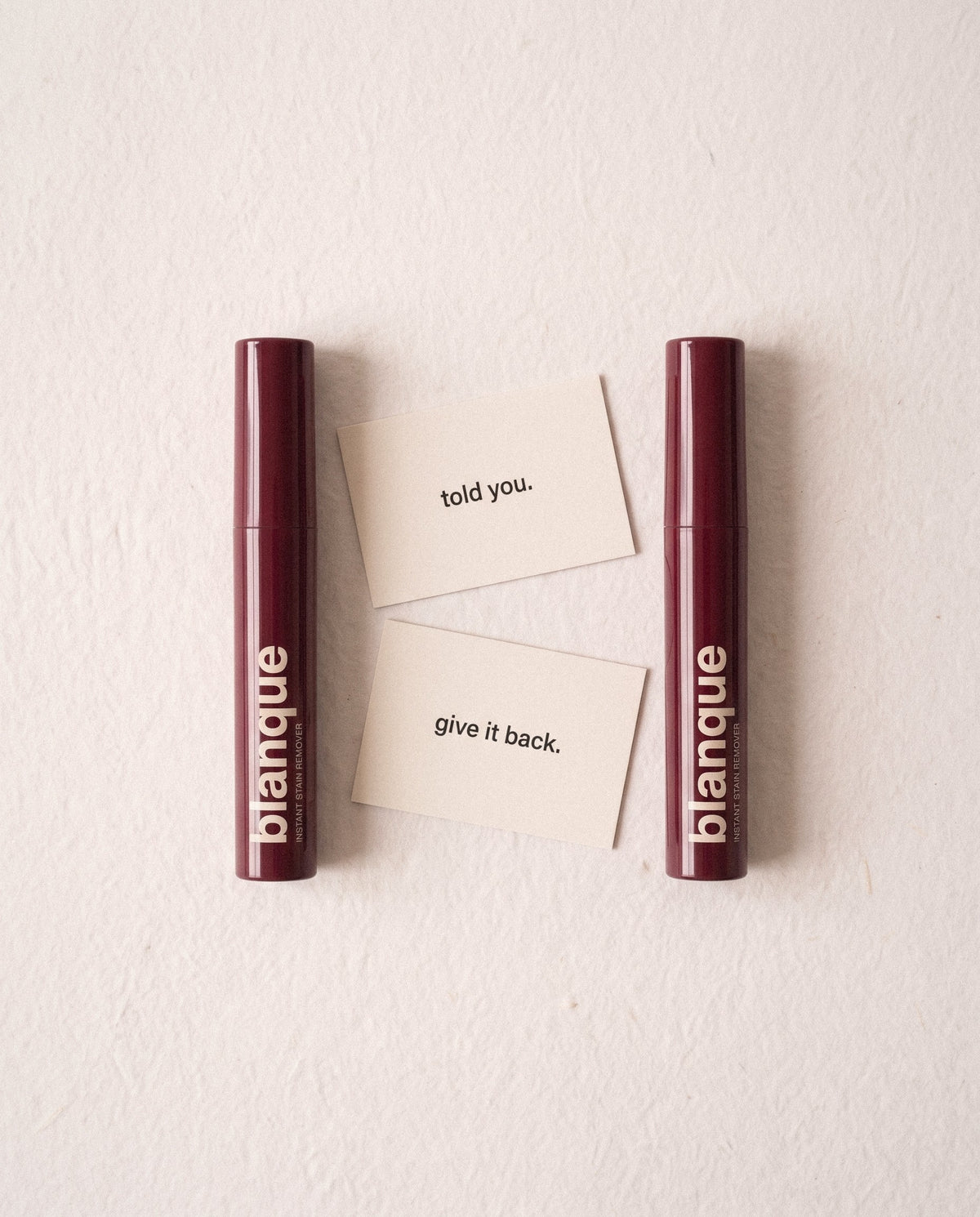 Two pens and the two cards: Told you. and Give it back.