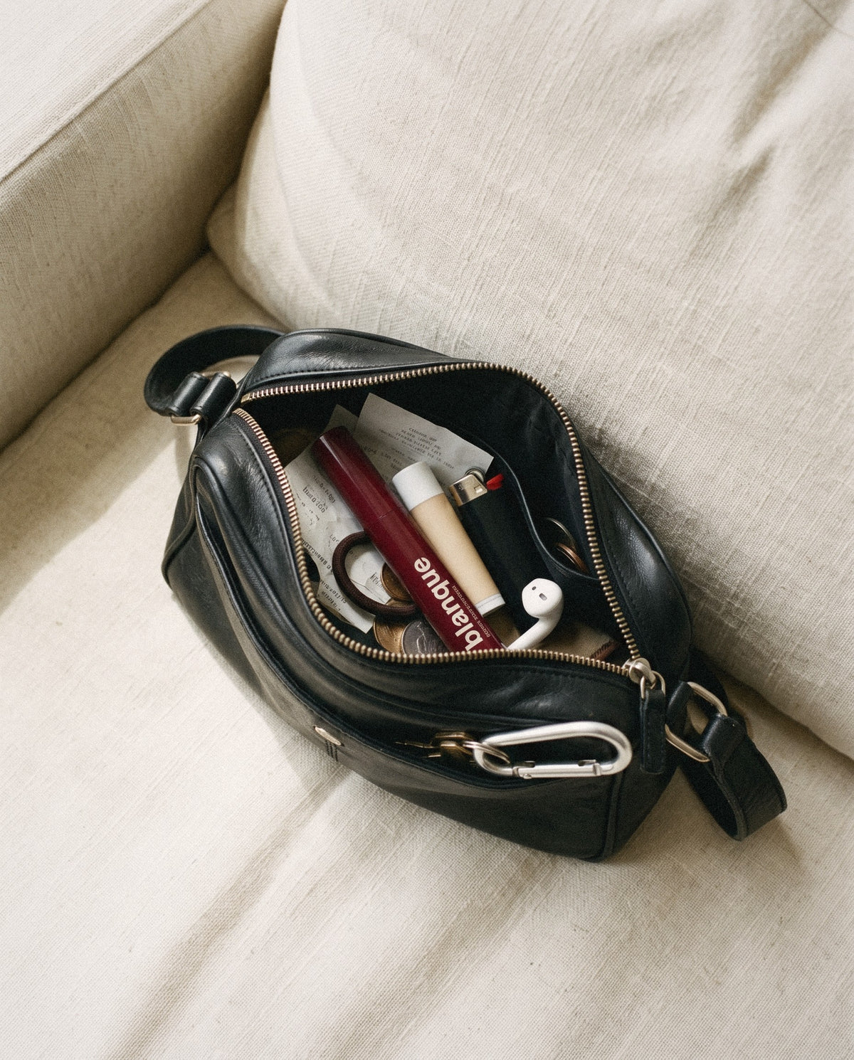The pen in a small black bag between a lip balm and a lighter.